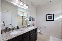 Double granite vanities in primary bathroom.