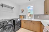 This is the largest of three laundry rooms in the home—offering full-size functionality, generous cabinetry, and space to work, fold, and organize with ease.