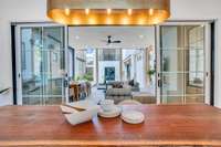 Open the sliding doors and the dining room transforms-connecting directly to the screened-in patio for effortless hosting and relaxing evenings