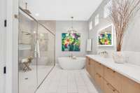 This dreamy, spa-like primary bathroom features double vanities, a freestanding soaking tub, a massive 10' x 5' shower with dual shower heads and a separate rain shower, plus a private water closet for added comfort.