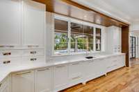 Oversized sink-level 9' window that overlooks the back terrace and pool.