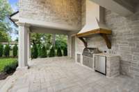 This hand-cut stone and hand rubbed real stucco pavilion with its outdoor kitchen overlooks the pool and gorgeous home.