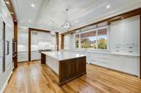 The island bar has seating for 4-6 people and you must see the gorgeous walnut waterfalls on each end. The walnut molding design is fabulous!