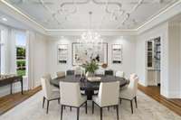 The dining room is banquet length featuring gorgeous custom ceiling moldings, a wide bay window and an adjacent elegant butlers pantry with ice and refrigeration + working pantry.