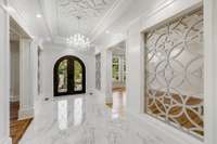 The gorgeous custom designed steel double entry door with limestone surround welcomes into the entry hall which opens the living room, dining room and 10' wide center hall.