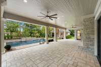 The perfect place to unwind. The porch is designed for dining and lounging while overlooking the beautiful pool and large backyard.