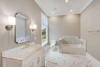 Private suite for Bedroom No. 1 features a marble surround soaking tub and heated floors.