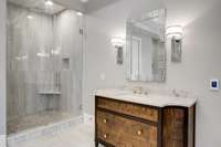 A view of the mirror image walnut vanity and one of two marble showers!