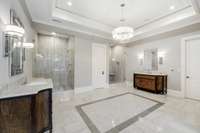 The Owners Suite Bath is luxurious and perfect for the modern couple with TWO showers featuring thermostatic Kalista plumbing fixtures, linear drains and gorgeous inset tile and marble patterns. And of course, heated floors!
