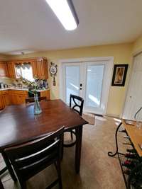 French doors open up to covered lighted deck with Sun Setter shades!