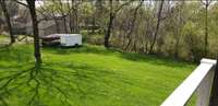 Spacious back yard behind the massive driveway.