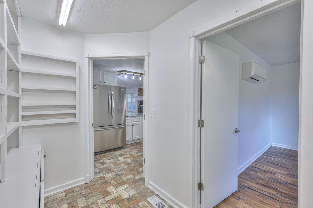 Walk-in pantry/laundry room with entrance to the office behind the kitchen