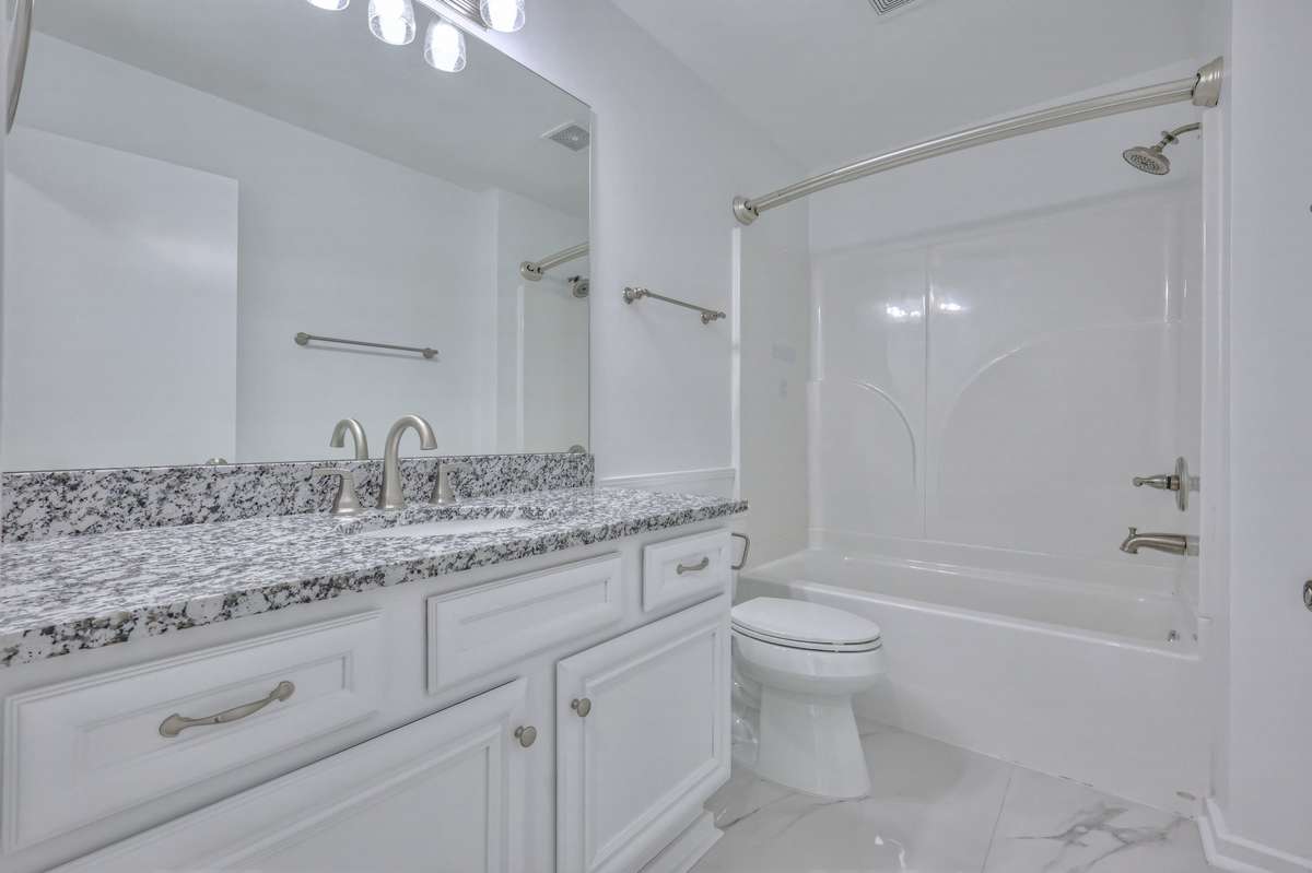 Full bath with granite countertop