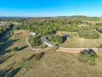 View of the driveway leading to the house/barn/pond