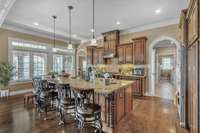Oversized Kitchen Island w/ Built In Icemaker, Double Sink & Dishwasher. Sleek Granite Countertops, SS Appliances & Tile Backsplash.