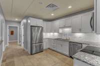 In Law Quarters (Basement Level) Full Kitchen w/ Granite Countertops, Tile Backsplash & SS Appliances