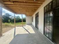 Covered outdoor grilling porch featuring a full Grilling station and wood-burning fireplace. Photo taken 6/26/25