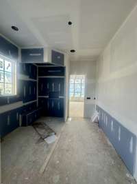 Primary Spa featuring a curbless walk-in shower, free-standing tub, double vanities, and a large walk-in closet with two built-in dress Built By Insignia Homes Photo Taken 6/29/25