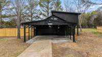 This is the detached 2 car garage with shop or storage room inside+ 2 car covered carport. The apartment is accessible through the garage or through the fence.