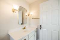Single vanity with ornate hardware and fixtures