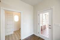 Utility room through the left door and large, entertainer's covered porch to the right