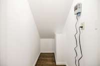 Storage space under stairs with septic alarm installed.