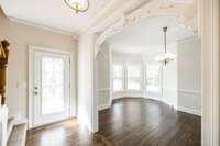 Refinished, authentic, hardwood floors and ornate style arch ways create a vibe that can't be matched.  Dining room with bay.