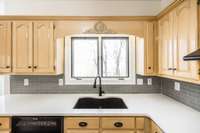 Single basin sink and backsplash add to the beauty of this kitchen.