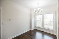 Informal dining/breakfast nook with natural light and views of backyard and woods.
