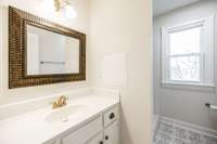 Upstairs hallway bathroom with single vanity and shower only