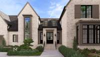 The front porch and double front doors create a grand, welcoming entry.