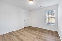 Bright and inviting second bedroom featuring amazing natural lighting for a warm and welcoming atmosphere.