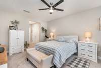 The primary suite offers a generous walk-in closet and a private bath with dual vanities and a separate shower.