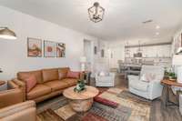 The spacious layout seamlessly integrates the living, dining, and kitchen areas, creating an inviting atmosphere perfect for both relaxation and entertaining.