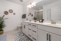 Step into the spa-inspired owner's suite bathroom, where luxury meets practicality. Featuring elegant double vanity sinks, this space offers ample room for personal comfort and convenience.