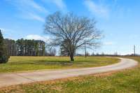 Long winding drive sets this home off the main road for privacy.