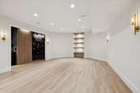 Basement level Rec Room opens to a custom wine stock and beverage station with wet bar.  LVP flooring throughout basement level.