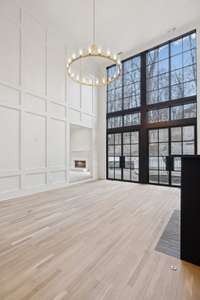 Floor to ceiling Pella windows allow plenty of dappled light through the private, heavily treed back yard.  Doors by Iron Lion.