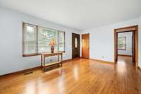 The living room, bathed in natural light from a large triple window, showcases gleaming hardwood floors! 6728 Jim Cummings Hwy Bradyville, TN 37026