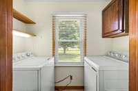 The utility room, equipped with abundant storage shelves and cabinets, includes a washer and dryer that convey with the property! 6728 Jim Cummings Hwy Bradyville, TN 37026