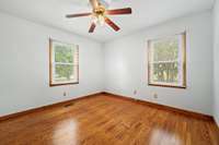 The primary bedroom features two windows that fill the space with natural light, complemented by a ceiling fan for added comfort.  6728 Jim Cummings Hwy Bradyville, TN 37026