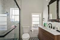 Huge walk in shower and designer marble floor tiles showcase the bathroom remodel