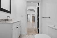 The centrally located guest restroom has a granite counter-top and a shower/tub combo.