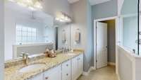 Master Bath with double vanities, a walk-in shower and stand alone tub.