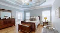 Master Bedroom with double trey ceiling fan and lots of light!  Check out the french doors leading into the Master Bath!