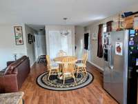 Dining area. Items of note: laminate flooring, Oak cabinets, Stainless Steel Appliances, Hidden laundry, 24x10 deck.