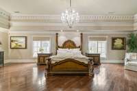 Primary bedroom with sitting area and stunning ceiling work!