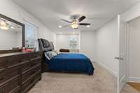 Huge primary bedroom with sitting area by window with storage