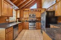 The kitchen features sleek stainless steel appliances and warm wooden cabinets. 4485 Coconut Ridge Smithville, TN 36166