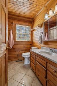 The primary bathroom features a clean and simple design with a single vanity, offering plenty of counter space and storage. 4485 Coconut Ridge Smithville, TN 36166